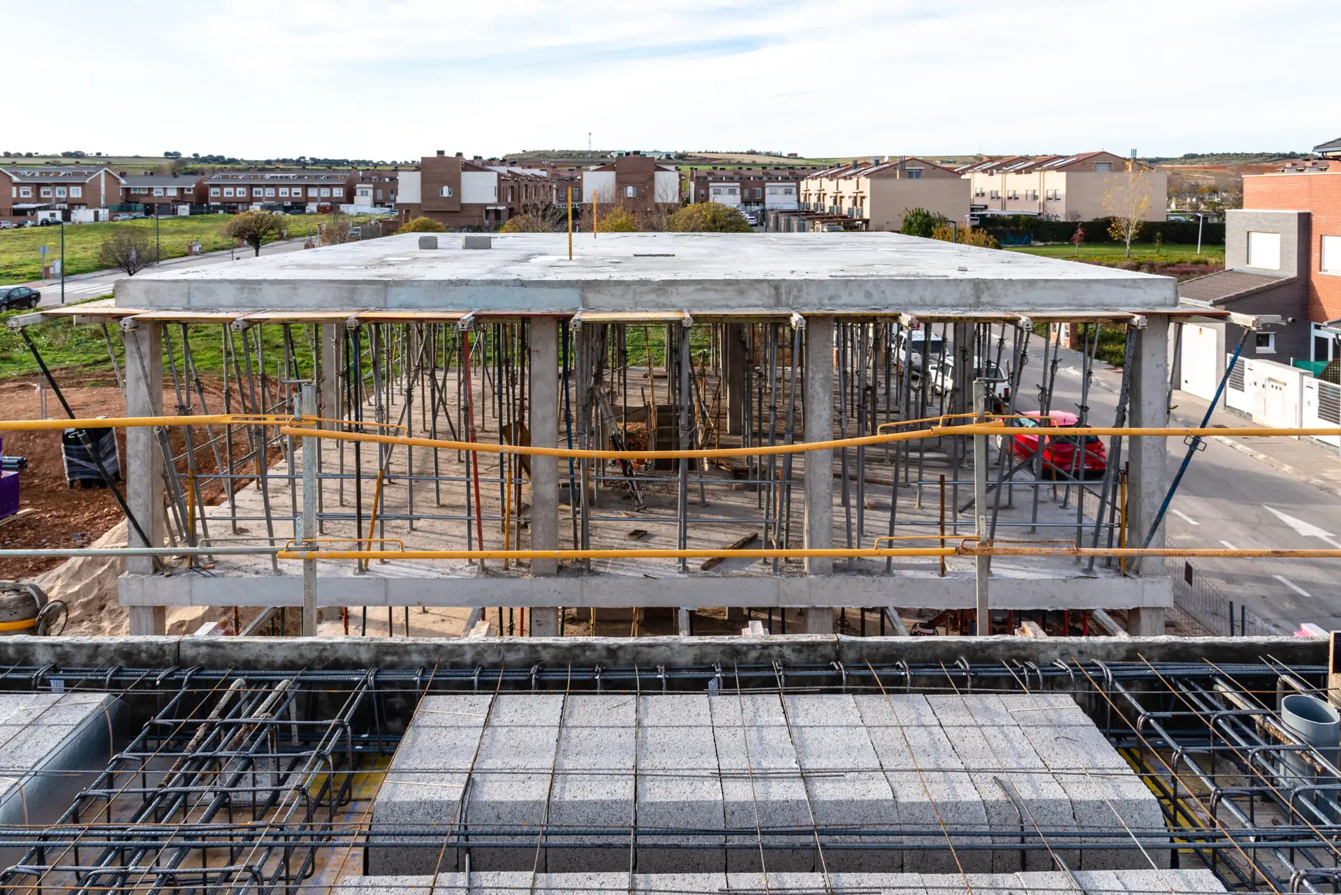 Construction site with steel formworks and reinforcing bars for pillars ready for concrete pouring
